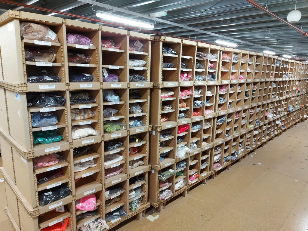 PIX flexible warehouse storage units in a warehouse with all pick faces filled with clothing products